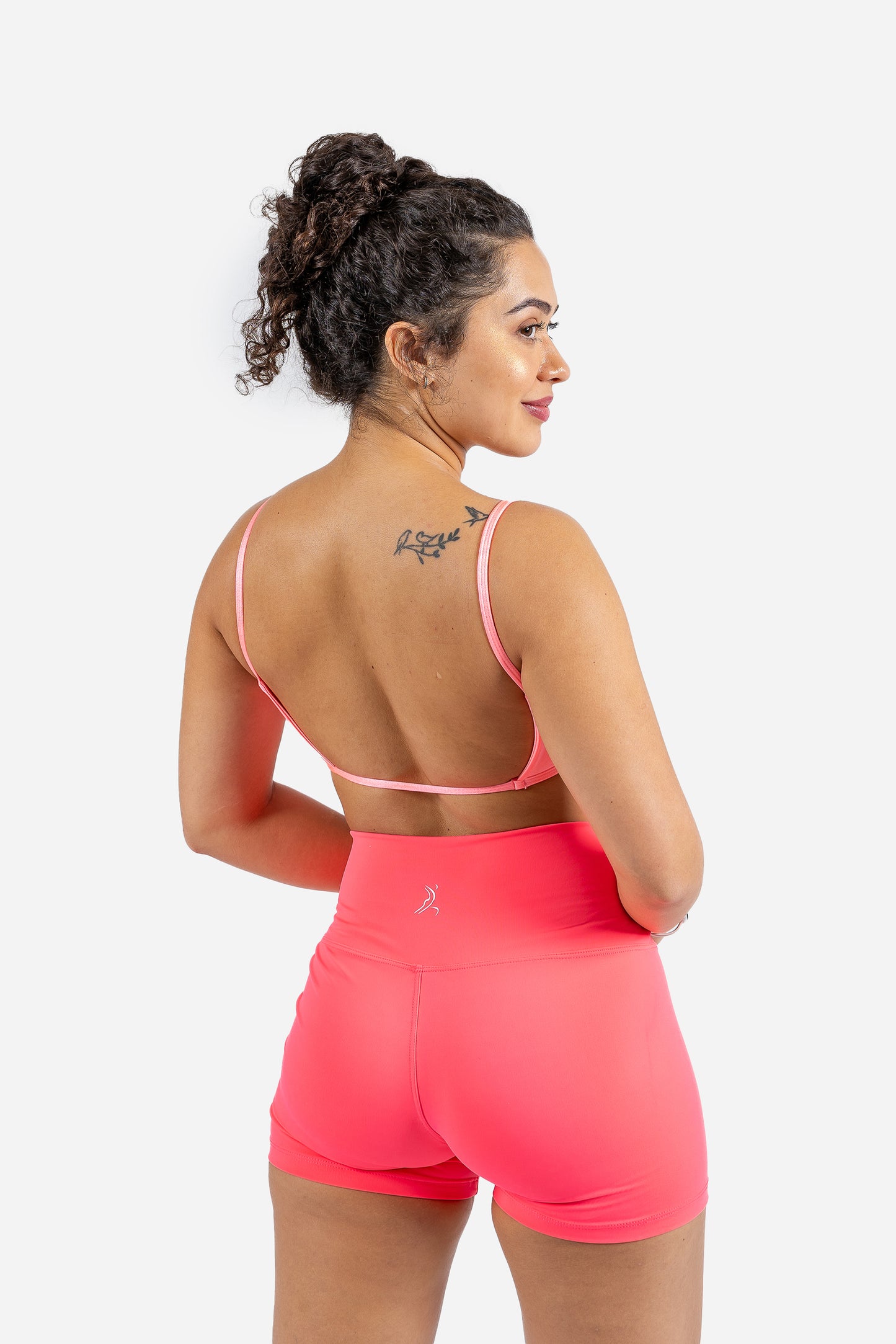 Thayane wearing Luxe Flow Curve Bra in Neon Pink – sculpted silhouette front view